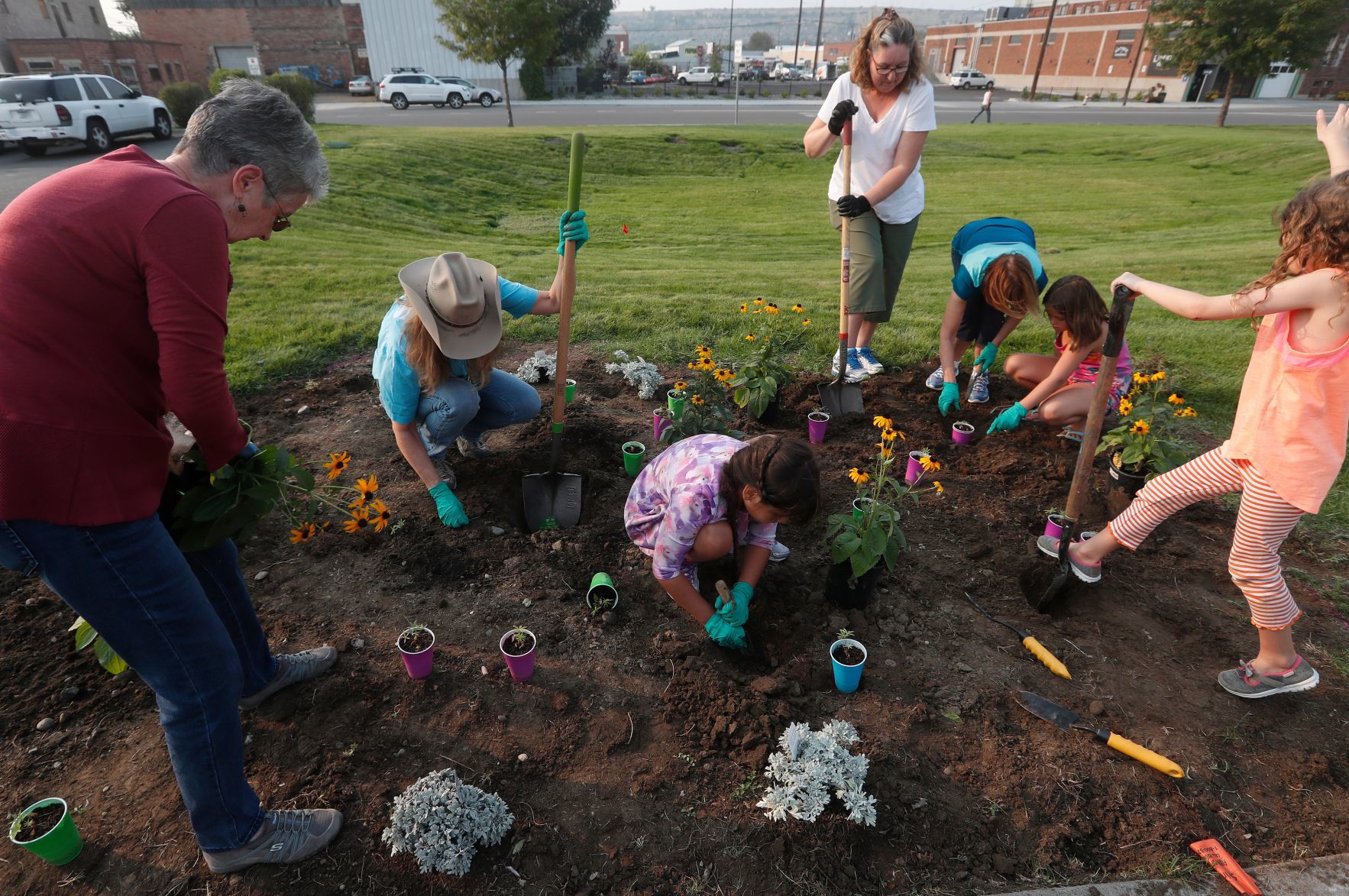 Girl Scouts plant flowers in Billings Depot Pocket Park